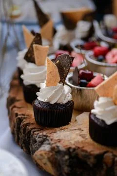 The wedding composition of delicious sponge fruit cakes decorated with juicy che Stock Photos