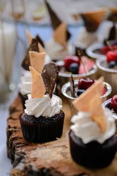The wedding composition of delicious sponge fruit cakes decorated with juicy che Stock Photos