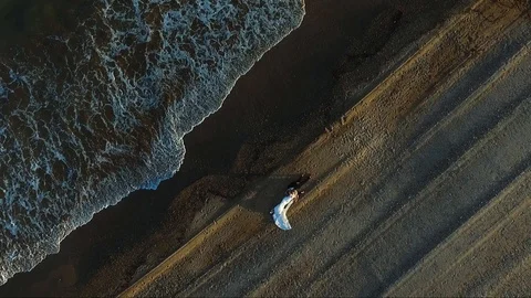 Wedding couple on the beach lying down on sand. Cinematic romantic scene Stock Footage 124465226