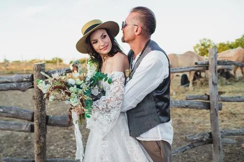 Wedding couple in the boho style on the ranch. Designer wedding bouquet. Stock Photos