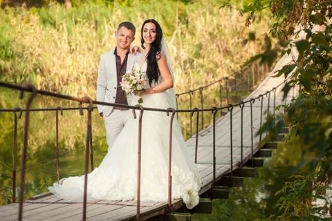 Wedding couple on bridge Stock Photos