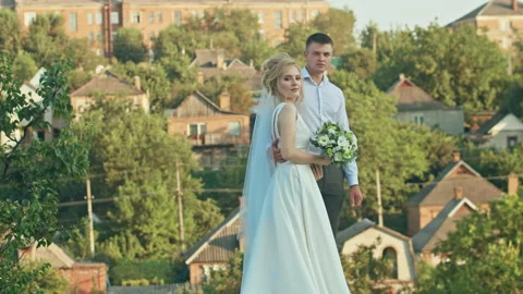 The wedding couple communicates on the background of the sky, the bride with a Stock Footage 167037997