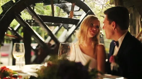 Wedding couple drinking champagne and softly kissing in old cafe Stock Footage 61036089
