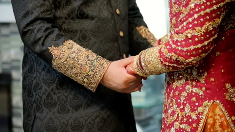 Wedding couple hands while holding each other, dressed in traditional red and Video stock 310629129