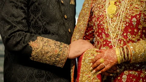 Wedding couple hands while holding each other, they dressed in the traditional Video stock 310630129