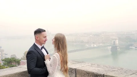 Wedding couple hugging on the background of the old city landscape Stock Footage 129559008