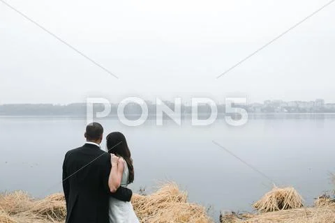 Wedding couple at the lake shore Stock Photos