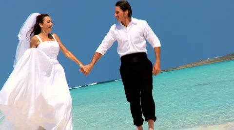 Wedding Couple Laughing & Dancing on the Beach Stock Footage