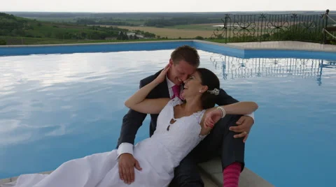 Wedding Couple Pool View Giggle -  4k - Slow Motion Stock Footage 53079520