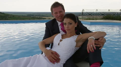 Wedding Couple Pool View Serious  -  4k - Slow Motion Stock Footage 53080617