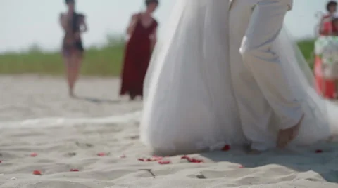 A wedding couple walking on the beach to the altar Stock Footage 50451029