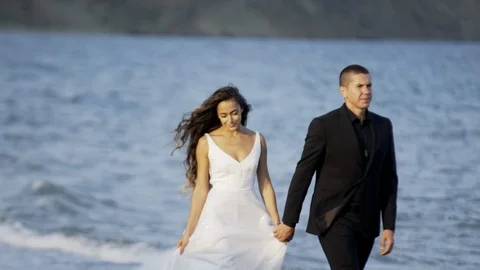 Wedding couple walking on beach Stock Footage 97878811