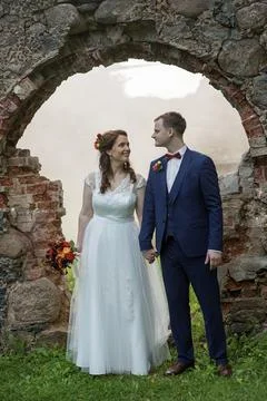 Wedding Couple Walking Forward Through Arch Stock Photos