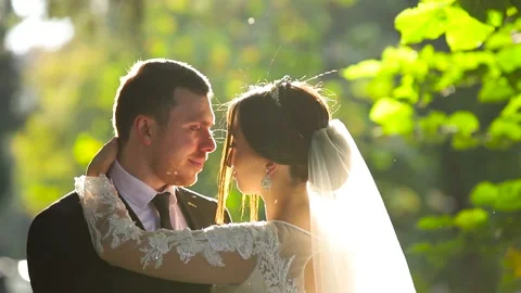 Wedding couple walks in the park Stock Footage 130180487