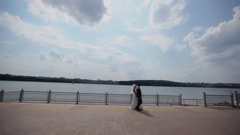 Wedding dance. newlyweds are dancing on the waterfront. bride and groom dance Stock Footage 80397288