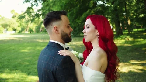 Wedding day. Happy bride and groom hugging and kissing. Red hair diversity Stock Footage 158741105