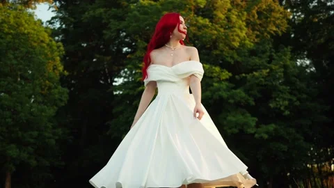 Wedding day. Happy bride with redhead whirling and laughing in the park Stock Footage 158741077