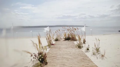 Wedding decor beach set up seaside with minimalist pampas grass arch with brown Stock Footage 308450790