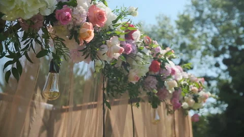 Wedding decor. Beautiful wedding arch with fresh flowers in the garden Stock Footage 143250944