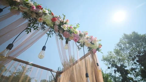 Wedding decor. Beautiful wedding arch with fresh flowers in the garden on a Stock Footage 143251206