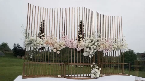 Wedding decor. Beautiful wedding arch with fresh flowers in the garden on a Stock Footage 196087414