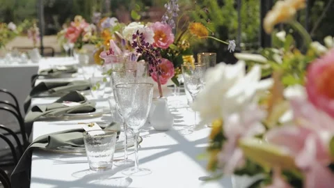 Wedding decor, decorated tables. An Elegant Outdoor Dining Setup Complete with Stock Footage 307918788
