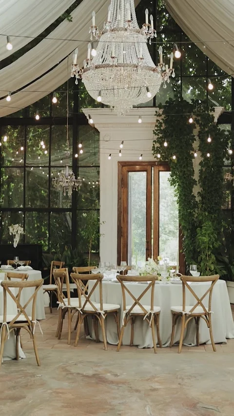 Wedding decor. This stylish venue features elegant tables, lush greenery, and Stock Footage 306155815