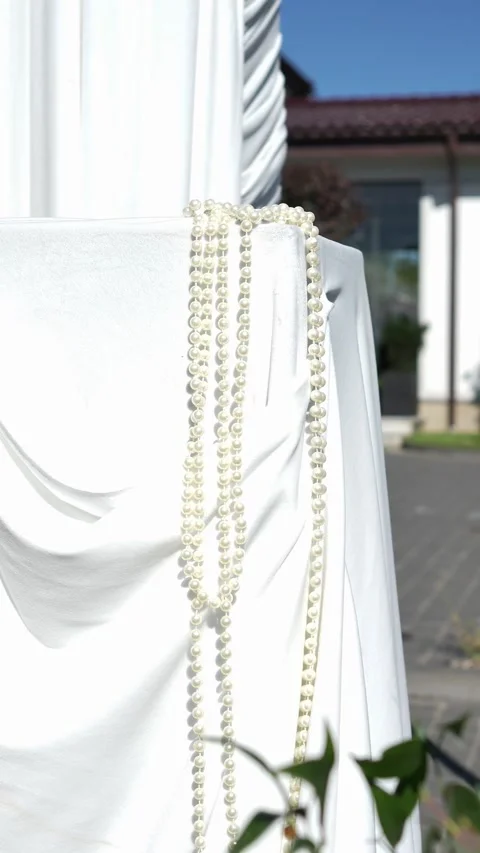 Wedding decor of white beads on white fabric on a wedding arch Stock Footage 318932801