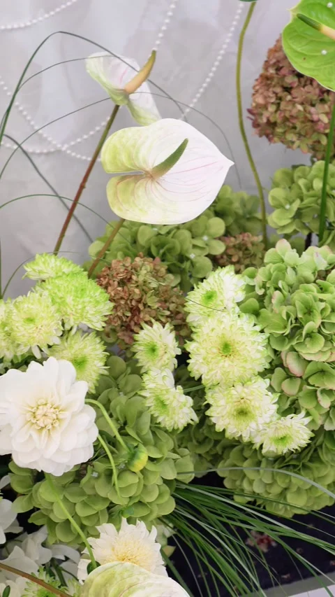 Wedding decoration of the bride's table. Flower arrangement in white and green c Stock Footage 318932585