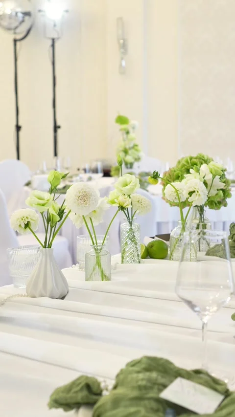 Wedding decoration of the bride's table. Flower arrangement in white and green c Stock Footage 318932608