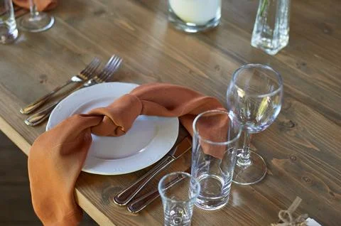 Wedding decoration. Floristics. Setting the table with brown napkins tied in a Stock Photos