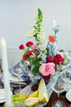 Wedding decoration on the white table with fruits, flowers and antiques Stock Photos
