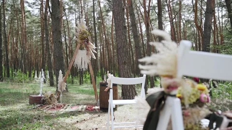 Wedding decorations, arch and chairs for outdoor wedding ceremony, a heavy wind Stock Footage 204928715