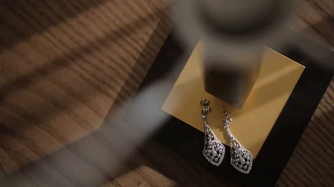 Wedding decorations Earrings under the lamp for the bride Bijouterie, ribbons Stock Footage 95246791