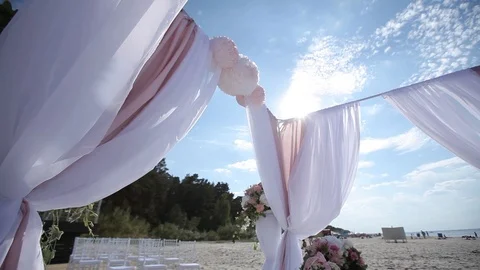 Wedding decorations from white and red flowers ceremony floristics near the sea Stock Footage 93722485