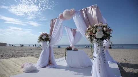 Wedding decorations from white and red flowers ceremony floristics near the sea Stock Footage 93722536