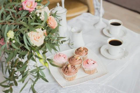 Wedding decorations zone - white table with bouquet and cupcakes Stock Photos