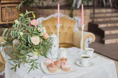 Wedding decorations zone - white table with bouquet and cupcakes Stock Photos