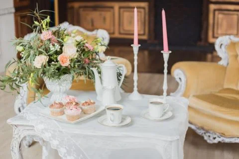Wedding decorations zone - white table with bouquet and cupcakes Stock Photos
