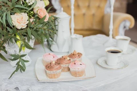 Wedding decorations zone - white table with bouquet and cupcakes Stock Photos