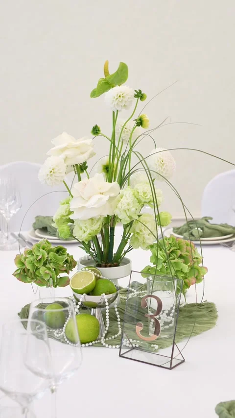 Wedding decorative flower arrangement for the table in white and green colors. E Stock Footage 318932553