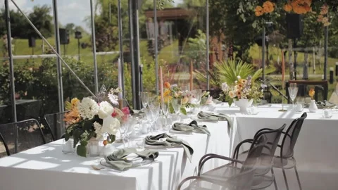 Wedding dining Setup in a Beautiful Greenhouse. Dinner table setup flower Stock Footage 307224365