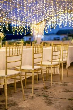 Wedding dining table setup using gold chiavari chair Stock Photos