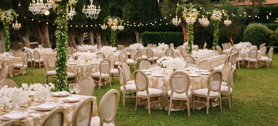 Wedding dinner table reception. Elegant tables for guests with cream tablecloths Stock Photos
