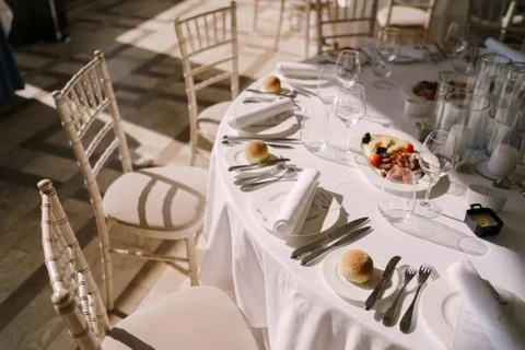 Wedding dinner table reception. Round banquet table with white tablecloth and Stock Photos
