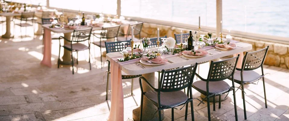 Wedding dinner table reception. There are many rectangular tables for guests Stock Photos
