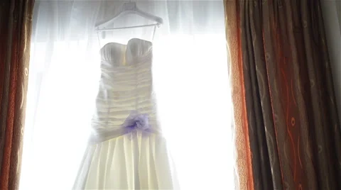 Wedding dress in front of the window Video stock 59975497