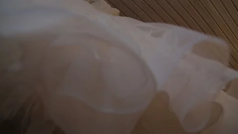 Wedding dress hanging in front of the window Stock Footage 87826218