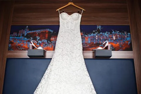 Wedding dress hanging on the wall in the hotel Stock Photos