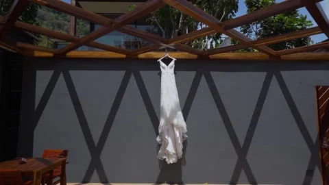 Wedding dress hanging the wall resort. Stock Footage